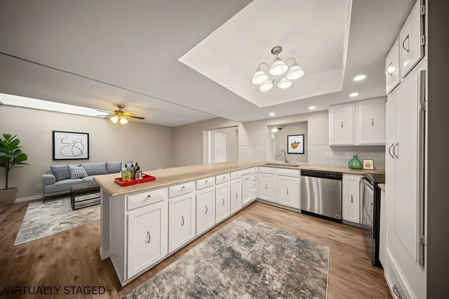 a kitchen with white cabinets and center island
