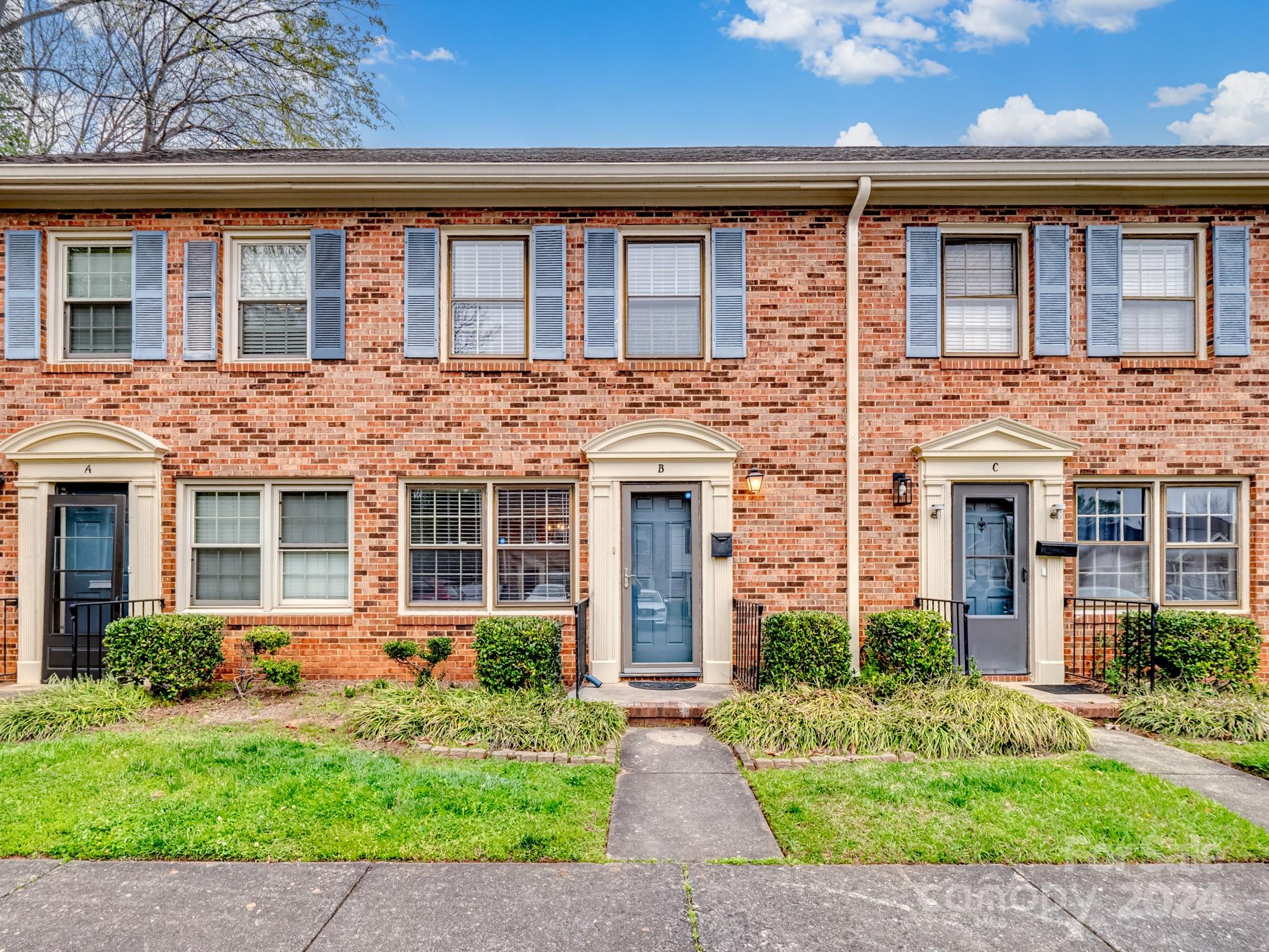 6306 Old Pineville Road, Unit B Charlotte, NC 28217 - Photo 15 of 16 front view of a brick house with a small yard