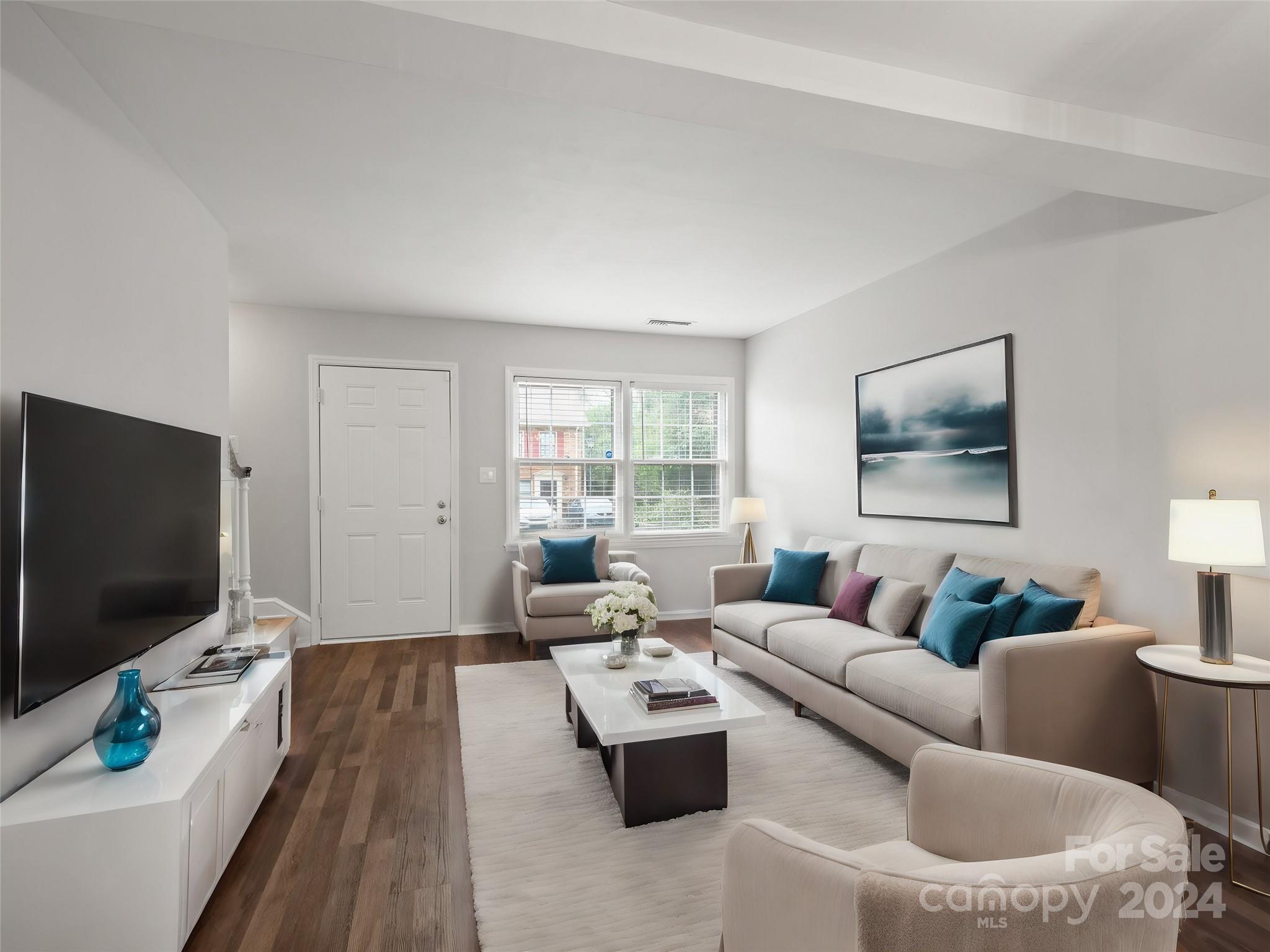 6306 Old Pineville Road, Unit B Charlotte, NC 28217 - Photo 2 of 16 a living room with furniture and a flat screen tv