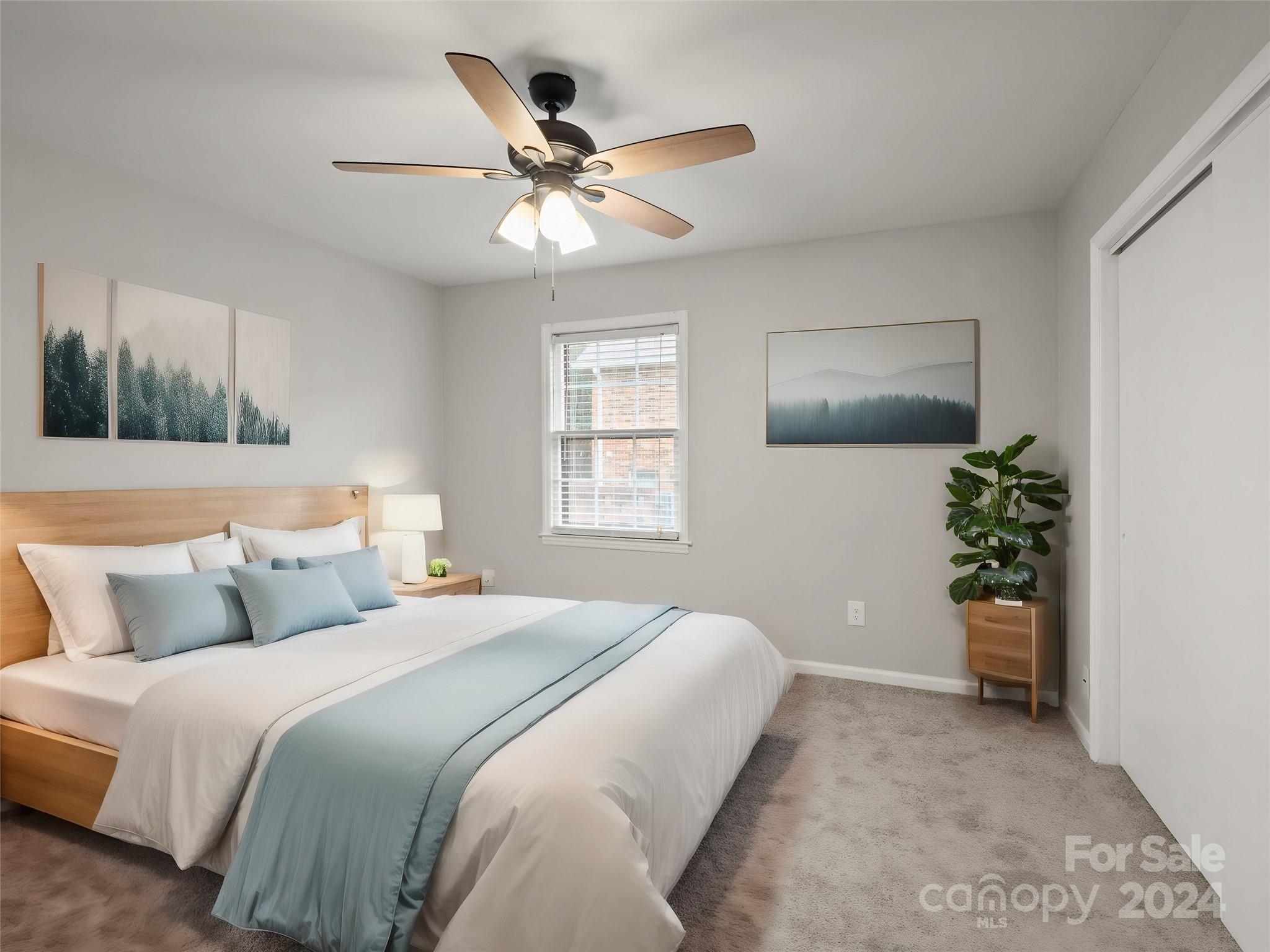 6306 Old Pineville Road, Unit B Charlotte, NC 28217 - Photo 4 of 16 a bedroom with a bed and a potted plant
