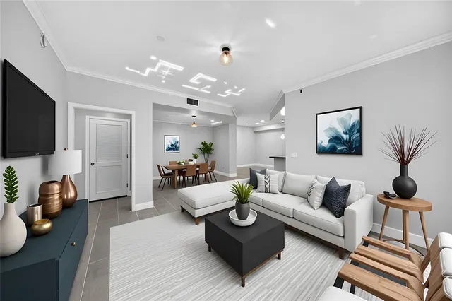 a living room with furniture a wooden floor and a flat screen tv