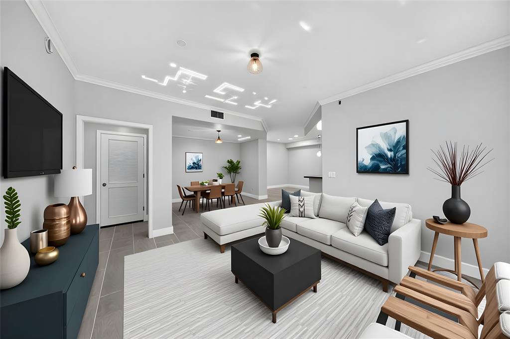 a living room with furniture a wooden floor and a flat screen tv