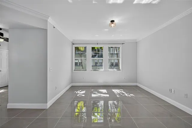 a view of patio with table and chairs under an umbrella with potted plants