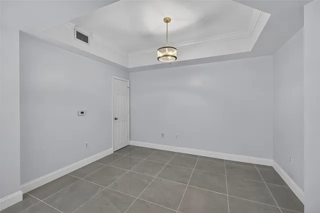a view of a patio with a table and chairs under an umbrella