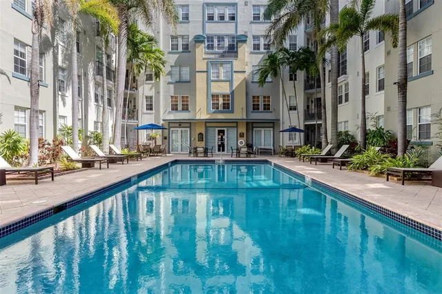 a living room with furniture flat screen tv and wooden floor