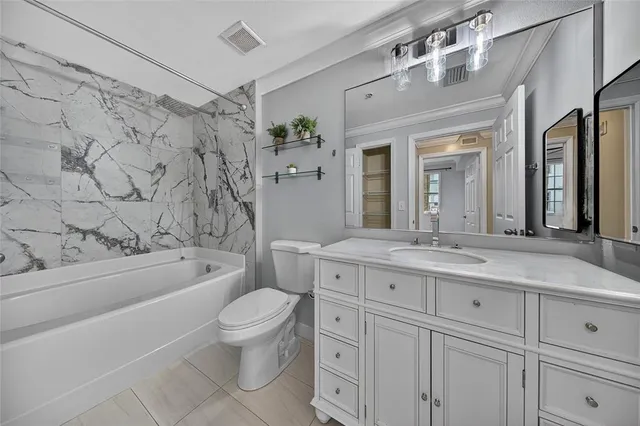 a large kitchen with stainless steel appliances granite countertop a sink and dishwasher a stove top oven with white cabinets