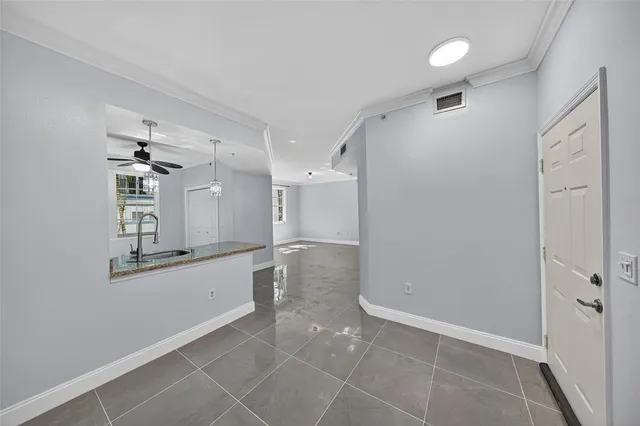 a kitchen with stainless steel appliances kitchen island granite countertop a refrigerator and a sink