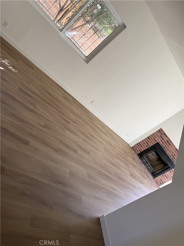 13716 Goleta Street Arleta, CA 91331 - Photo 22 of 28 a view of an empty room with wooden floor and a ceiling fan