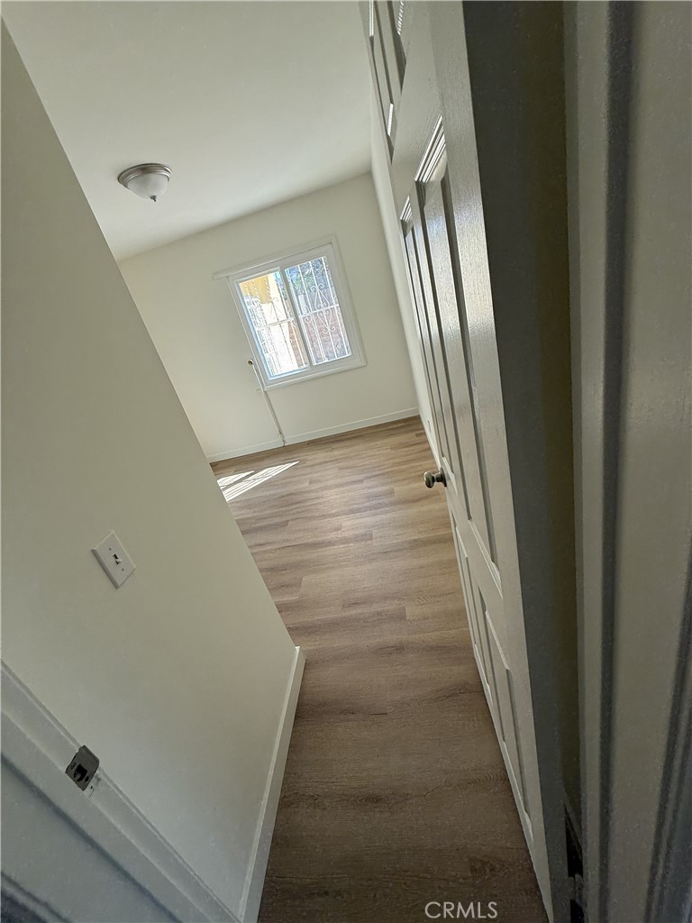 13716 Goleta Street Arleta, CA 91331 - Photo 9 of 28 a view of staircase with wooden floor and window