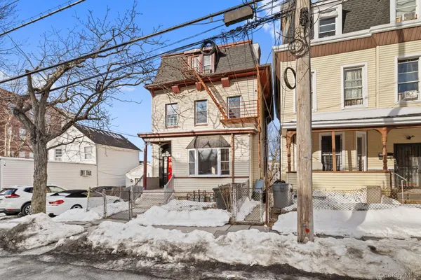 a view of a house with snow on the background