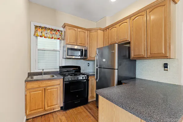 a kitchen with a refrigerator stove and microwave