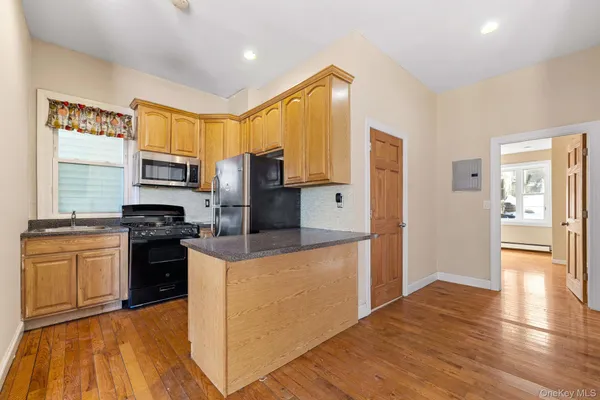 a kitchen with stainless steel appliances granite countertop a refrigerator stove top oven and sink