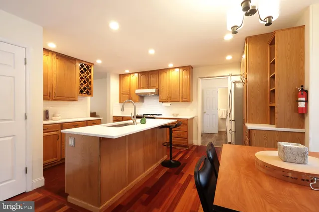 a kitchen with stainless steel appliances a stove a sink and cabinets