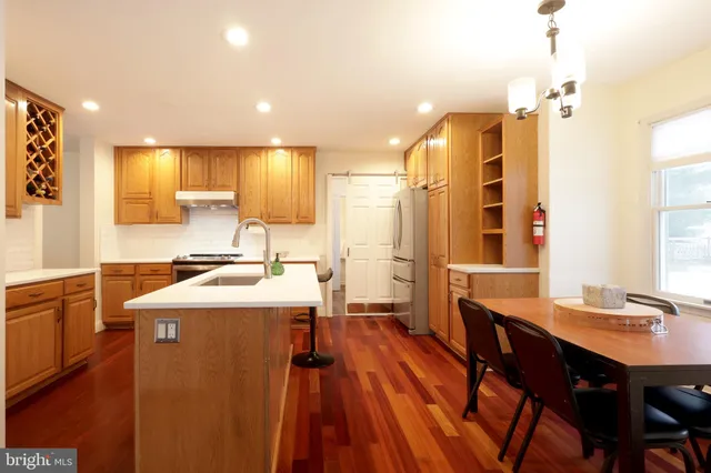 a kitchen with stainless steel appliances wooden cabinets and a stove top oven