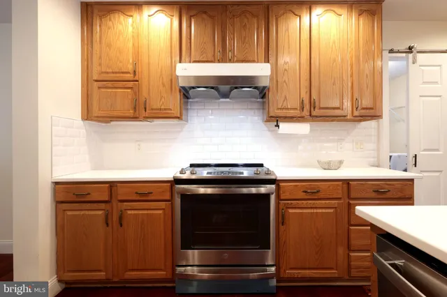a kitchen with a sink stove and cabinets