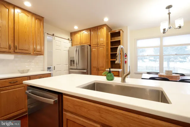 a kitchen with stainless steel appliances a refrigerator stove and microwave