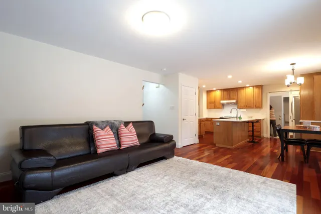 a living room with flat screen tv a lamp and a window