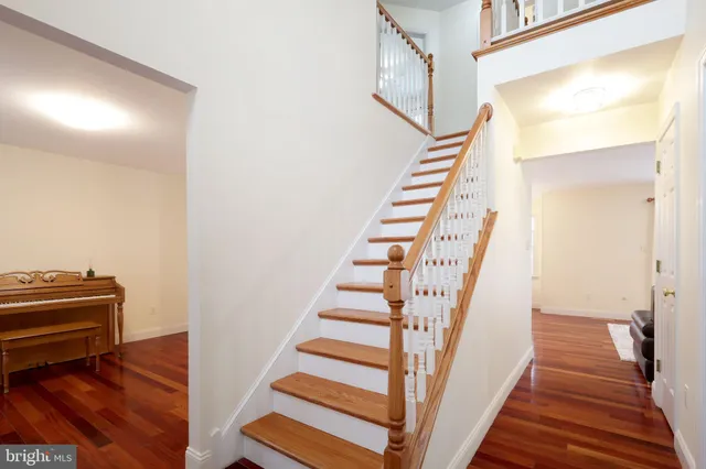 a view of empty room with wooden floor and closet
