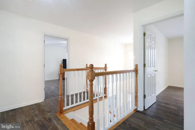 a view of hallway with wooden floor