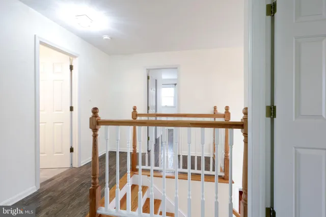 a view of a big room with wooden floor and windows