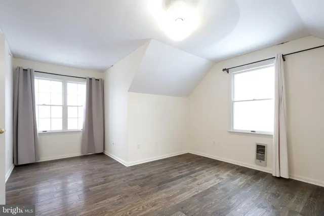 a front view of a house with a yard covered in snow