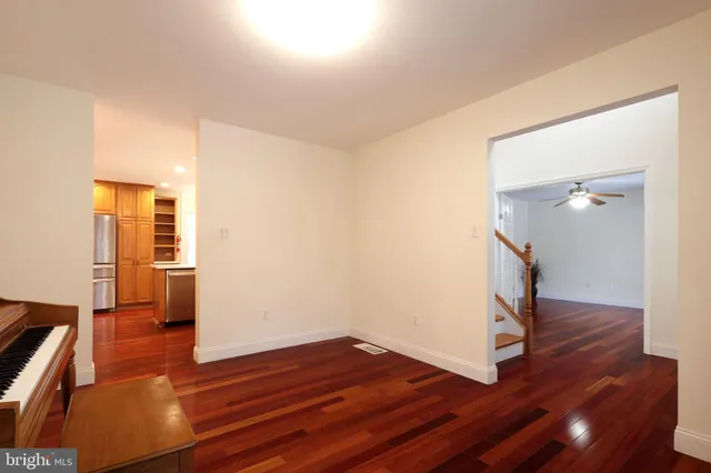 a kitchen with sink a refrigerator and chairs