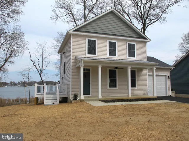 a backyard of a house with wooden deck and barbeque oven