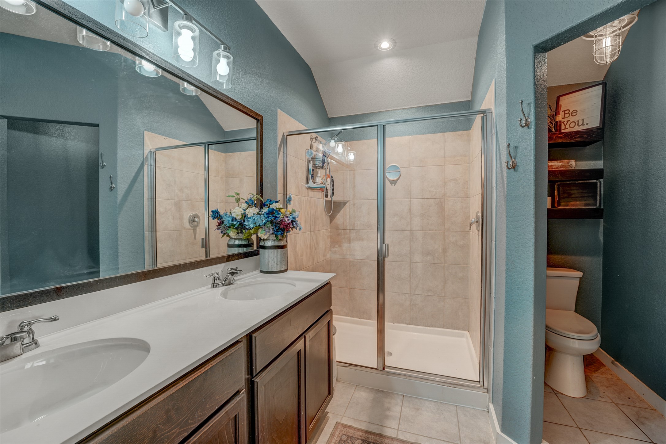 5806 Aviano Road Round Rock, TX 78665 - Photo 24 of 29 Double vanities and a spacious glass-enclosed shower create a practical, refreshed bathroom retreat.