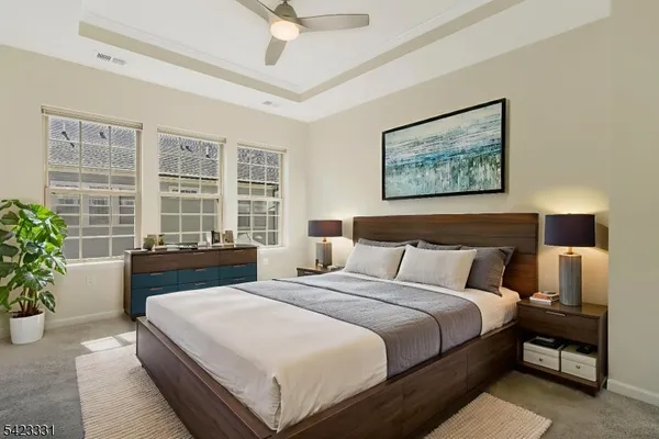 a bedroom with a large bed and a potted plant