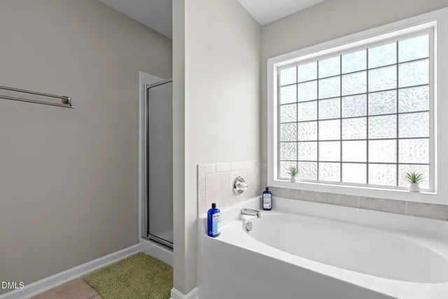 a bathroom with a bathtub and shower