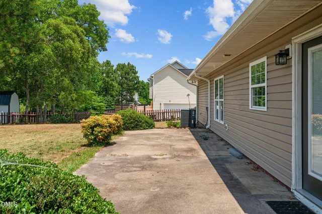 a swimming pool with outdoor seating and yard