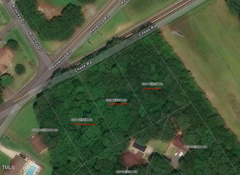 a backyard of a house with lots of green space and a lake view