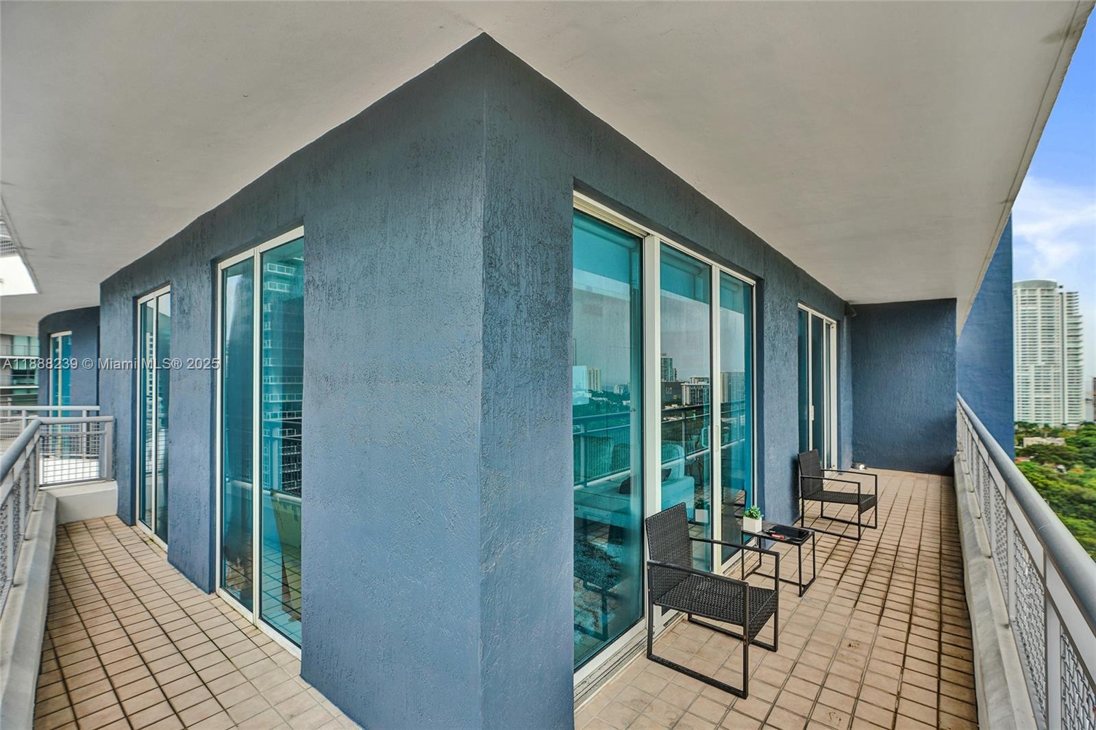 60 Southwest 13th Street, Unit 1721 Miami, FL 33130 - Photo 4 of 9 a balcony with chairs and a potted plant
