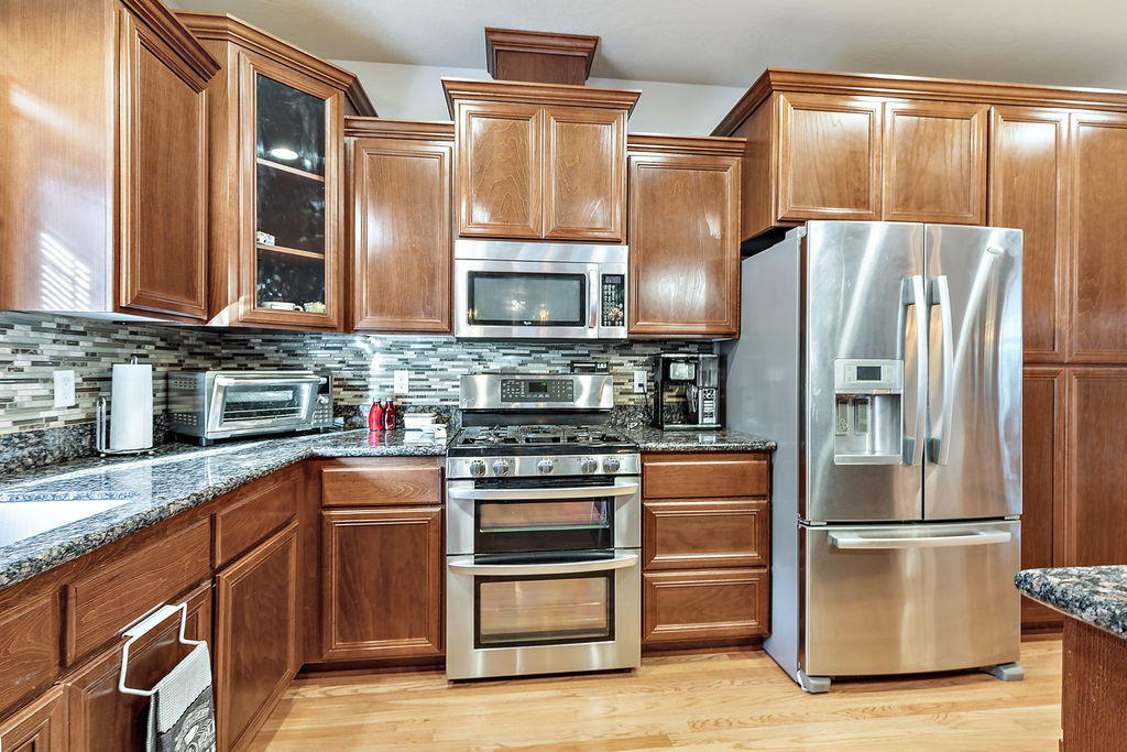 2198 Rabun Way Central Point, OR 97502 - Photo 23 of 47 a kitchen with stainless steel appliances granite countertop a refrigerator and a stove