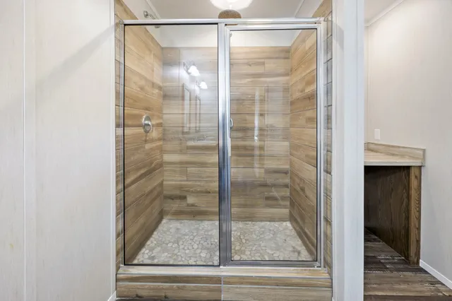 a bathroom with a glass shower door