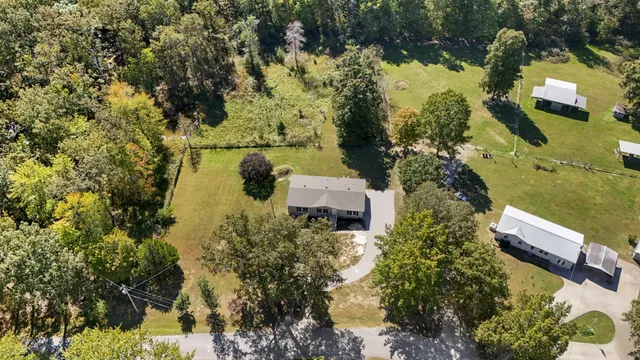 an aerial view of a house with a yard and lake view
