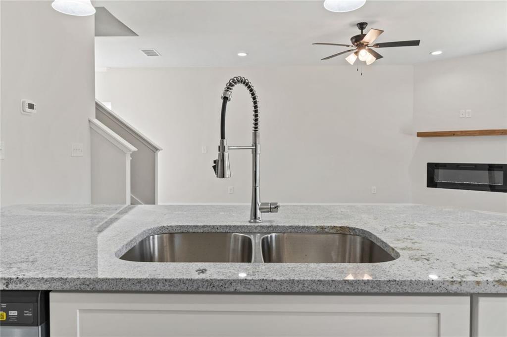 769 Dawn Place Alto, GA 30510 - Photo 13 of 40 a kitchen with a sink a faucet a light fixture and a glass door