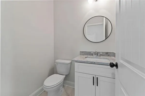 a bathroom with a toilet a sink and a mirror
