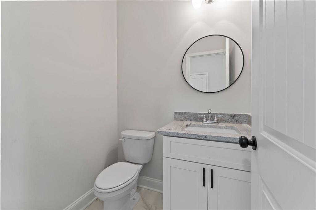 769 Dawn Place Alto, GA 30510 - Photo 16 of 40 a bathroom with a toilet a sink and a mirror