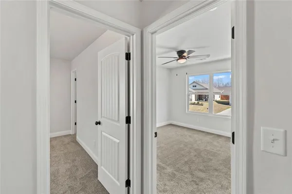 a view of a hallway with closet and front door