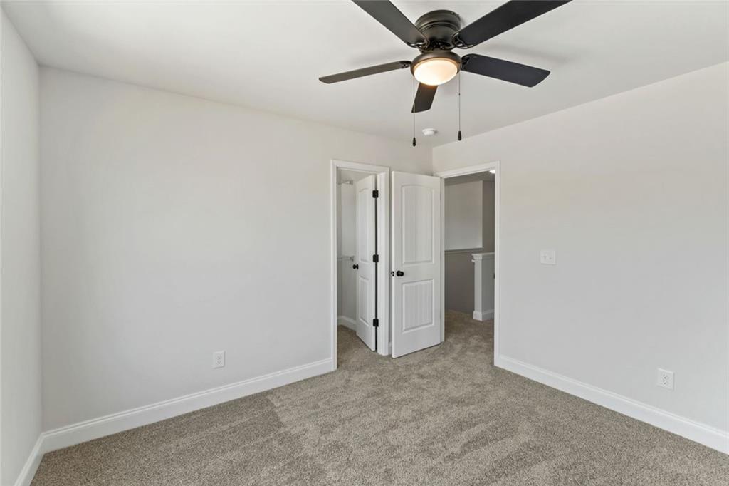 769 Dawn Place Alto, GA 30510 - Photo 24 of 40 an empty room with a ceiling fan and a fan