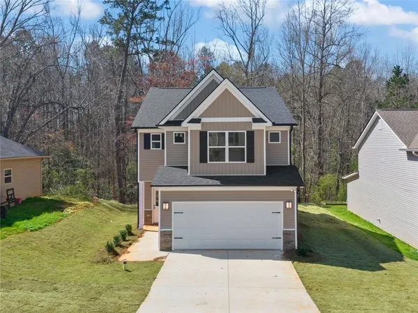 a front view of a house with a yard