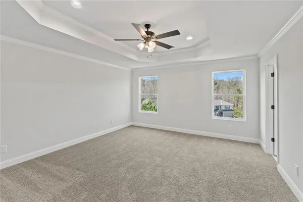 an empty room with window and ceiling fan