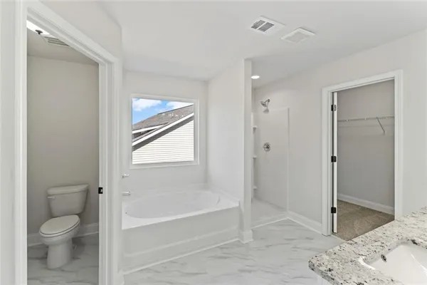 a bathroom with a granite countertop toilet sink and shower