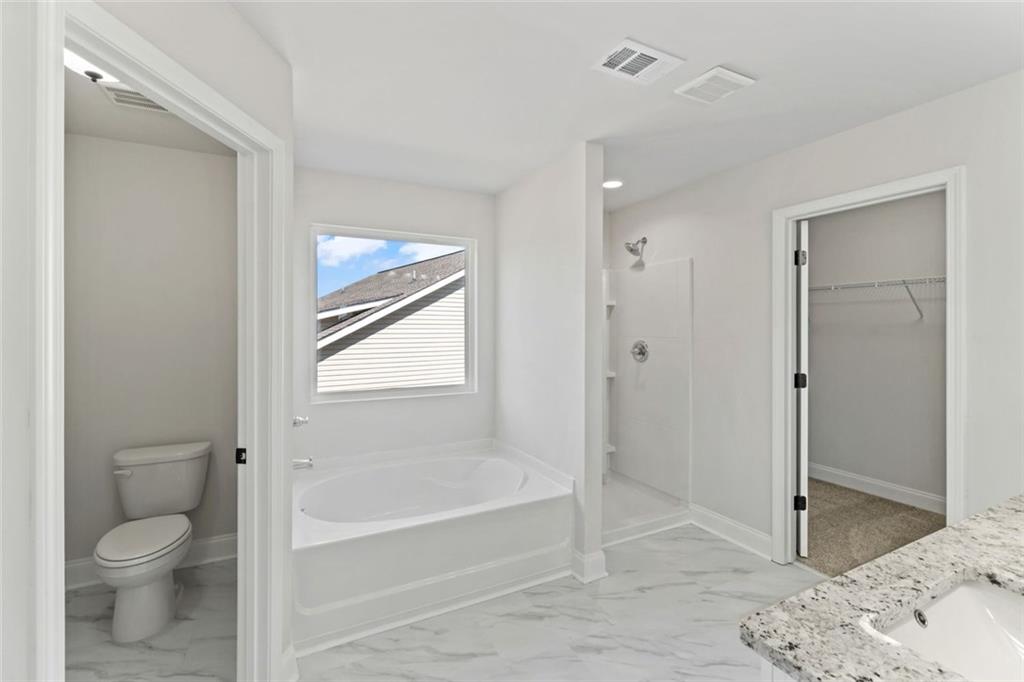 769 Dawn Place Alto, GA 30510 - Photo 33 of 40 a bathroom with a granite countertop toilet sink and shower