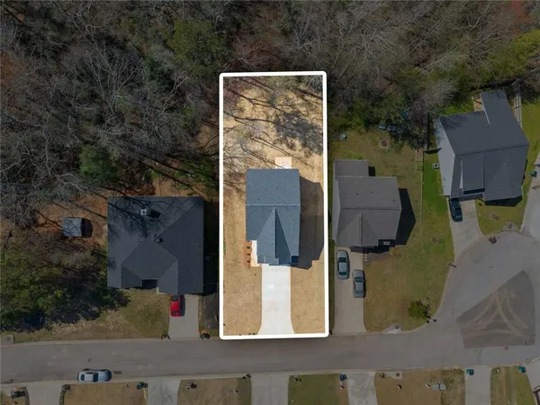 an aerial view of residential houses with outdoor space