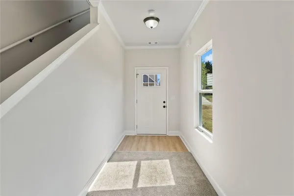 a view of a room with wooden floor and window