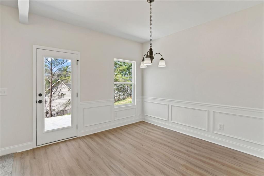 769 Dawn Place Alto, GA 30510 - Photo 9 of 40 a view of an empty room with wooden floor and a window