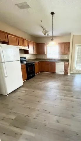 a kitchen with stainless steel appliances a stove and more cabinets