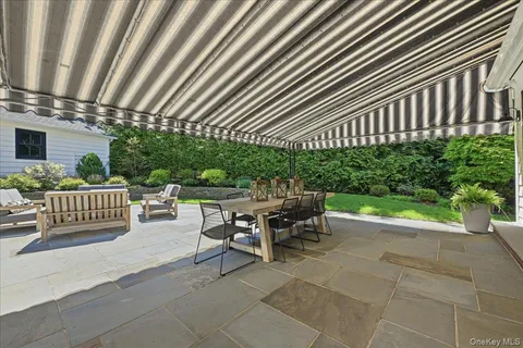 a view of a patio with a table and chairs